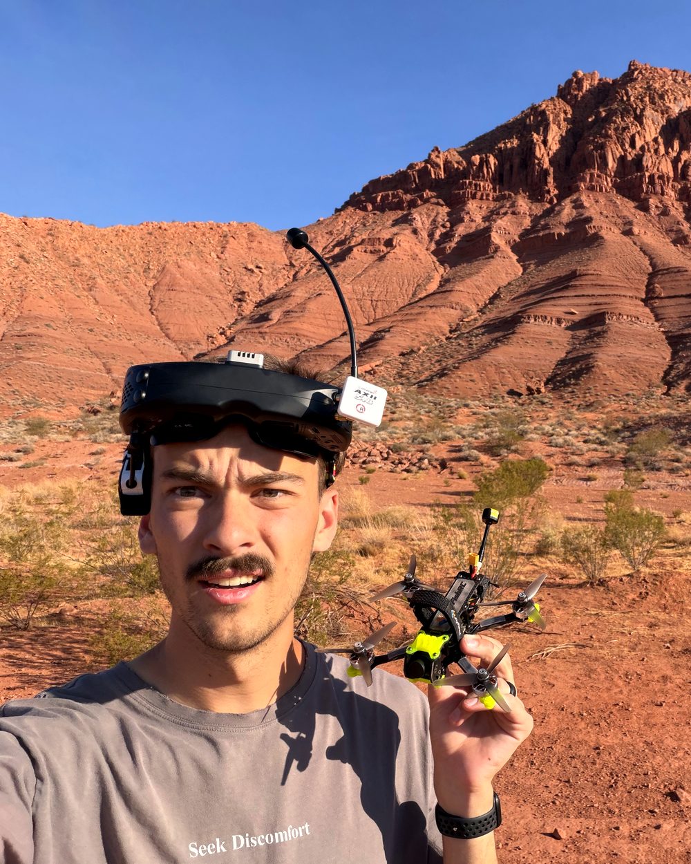 Alec in the Utah desert, holding his 3.5-inch quad